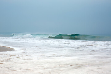 Beautiful blue waves with foam near the shore of the Indian Ocean