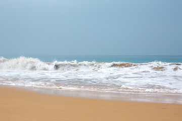 Beautiful waves with foam near the shore of the Indian Ocean