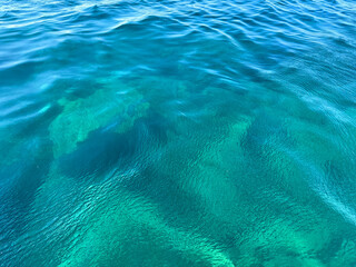 Ocean blue turquoise waves clear ripples sea water surface.