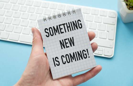 Something new is coming. Business concept. text on white notepad paper on white keyboard