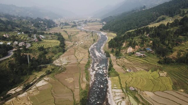 aerial view of river and paddy farmland in Nuwakot, Nepal.