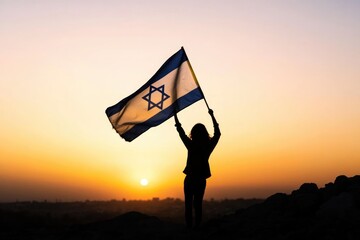 Silhouette of a Person Holding Israeli Flag at Sunset - National Pride and Patriotism Concept