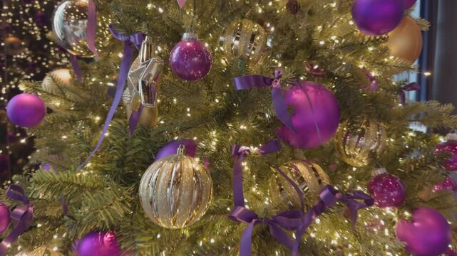 Vibrant Christmas Tree with Glittering Lights in Cozy Holiday Setting.