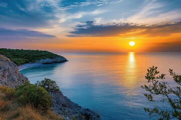 Fototapeta premium Sunset over a tranquil coastal landscape with cliffs and calm water