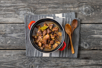 beer braised pork stew in a red pot