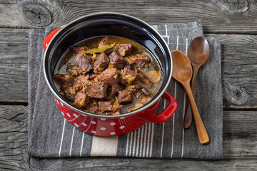 beer braised pork stew in a red pot