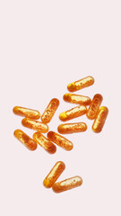 Place for text. Many yellow medicines on a pink background. Lots of vitamins. Style.