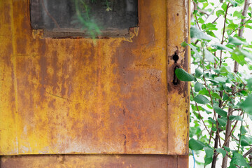 A close-up of a weathered electrical box, its rusty surface revealing the beauty of decay. The lock and surrounding corrosion evoke the passage of time and the fragility of industrial objects