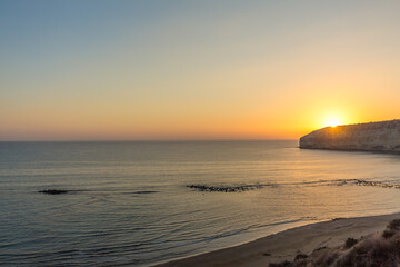 Sunset at Zapallo Bay: Twilight with Sun Setting Behind Mountain