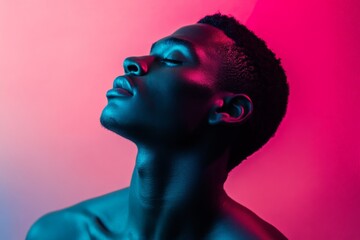 A captivating profile shot of a man against a gradient background, emphasizing his strong features and creating an impactful visual with striking lighting.