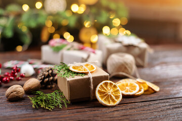 Christmas and zero waste, eco friendly packaging gift on wooden background under christmas tree....