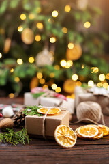 Christmas and zero waste, eco friendly packaging gift on wooden background under christmas tree. Eco christmas holiday concept. Sustainable christmas