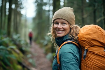 A happy adventurer smiles while exploring a nature trail path, reflecting joy, adventure, and the beauty of outdoor activities amidst lush green scenery.