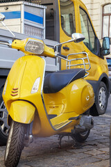 yellow scooter on the background of a yellow car cabin