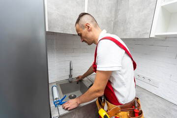 Cleaning Blocked Drain Clog In Kitchen Sink Using Plunger