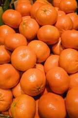 A vibrant pile of fresh, ripe tangerines, showcasing their bright orange color and natural texture. Perfect for healthy food, fruit, or citrus concepts.