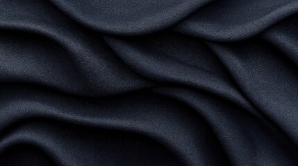 Fototapeta premium Close-up view of dark gray cloth with flowing folds and smooth texture creating an elegant abstract background with soft curves and shadows.