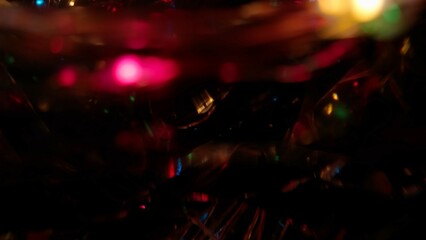 Blurred colorful lens flare motion studio lightning, wire garland with bokeh effect on dark...