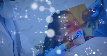 Image of molecules over caucasian male dentist and girl patient