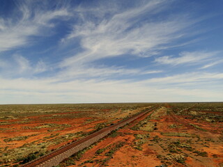 Naklejka premium Australian Landscape with a road in the Outback and Red Centre
