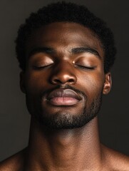 Obraz premium Contemplative young African black man eyes closed in mindful meditation