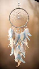 Obraz premium A dreamcatcher adorned with white and blue feathers hangs gracefully, capturing the light softly. Intricate beadwork enhances its delicate design, creating a calming atmosphere.