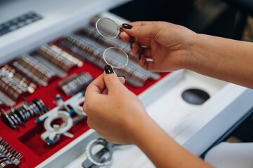 Ophthalmologist is picking different lenses that are in the kit