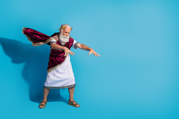 Full body photo of handsome senior male powerful cast spell wear ancient greek god king dress...