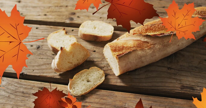 Image of frame with fall leaves over baguette - Powered by Adobe