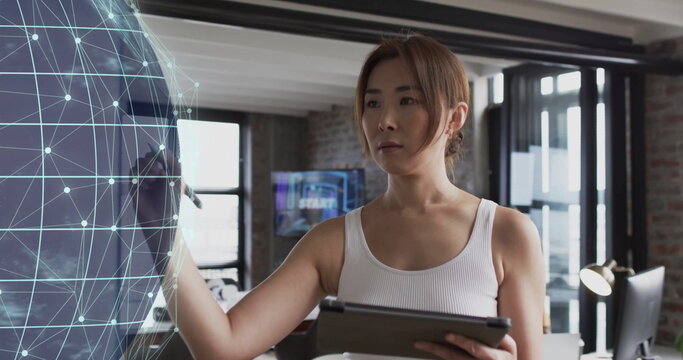 Image of globe with connections and data processing over asian businesswoman in office
