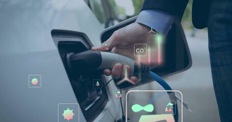 Image of eco icons over caucasian man charging electric car