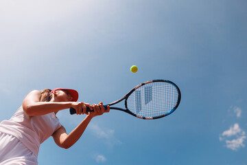 young tennis player playing tennis, bottom view