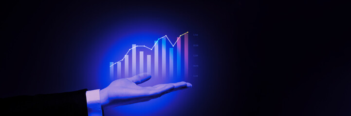Conceptual holographic display with bar and line graphs in hand, representing advanced business analytics and success. Concept of business, analytics, technology, innovations. Banner