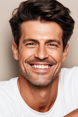 Fototapeta premium A man with a beard and a smile on his face. He is wearing a white shirt. Concept of happiness and positivity