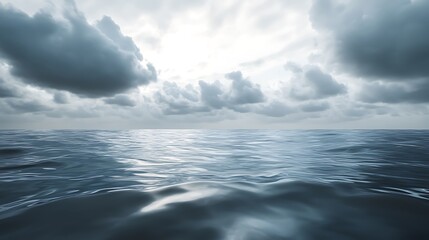 Fototapeta premium A serene seascape with rippling water and overcast skies, evoking tranquility and reflection.