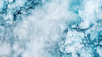 Close-up of icy blue and white abstract marble texture resembling frosty natural patterns.