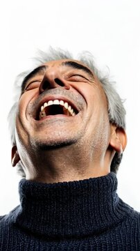 Joyful man laughing against a plain white background, showcasing pure happiness and excitement in a relaxed setting