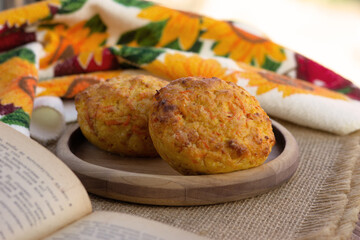 Breakfast on the windowsill. Two muffins made of cottage cheese and pumpkin. Healthy eating in the morning against the backdrop of nature.