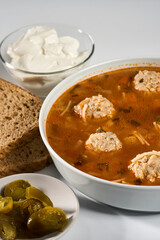 Meatball soup with bread, cream and jalapeno
