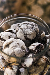 Chocolate marble cookies with cracks.Marble cookies in a glass jar in a coffee shop. Marble cookies close-up.