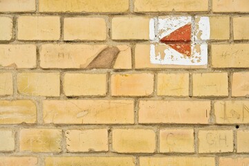 Weathered brick wall with play button symbol