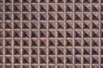 Textured metal surface with raised pyramids