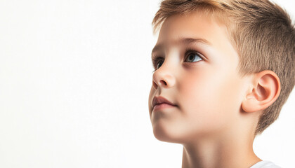 Fototapeta premium Young boy gazing thoughtfully with curious expression