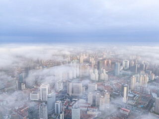 Aerial view of Shanghai skyline in the fog at sunrise