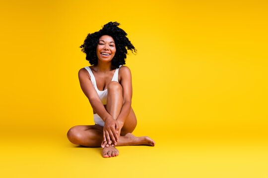 No filter studio photo of pretty shiny woman underwear enjoying self acceptance blank space isolated yellow color background