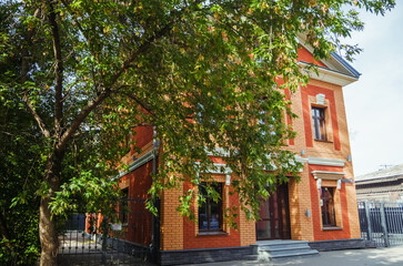 Beautiful brick facade of a building in Irkutsk, showcasing architectural style amidst autumn colors.