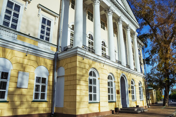 Naklejka premium Building with Columns and large windows under an autumn sky. Irkutsk city, downtown historical building.