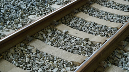 Subway metal rails laid on gravel floor   