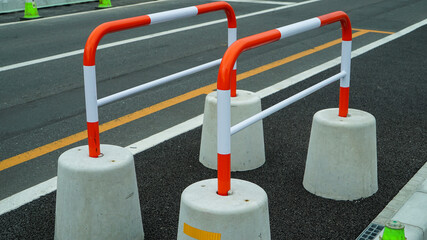 Red and white striped pattern metal barricade for road construction