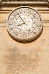 Unique calendar clock on the facade of Saint Paul cathedral in historic Mdina, Malta